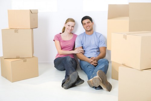 Professional movers packing office equipment